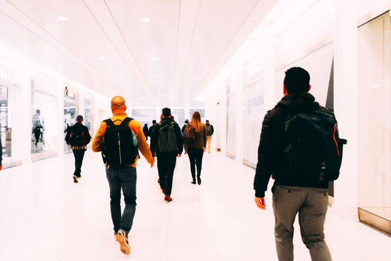 Travellers walking through an airport departures hall